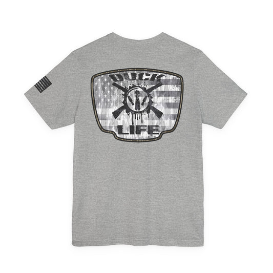 White American Flag Duck Hunting Badge T-Shirt – Mossy Camo Print, Crossed Guns & Duck Skull Graphic